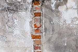 Plaster and red brick wall damage.