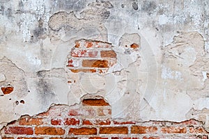 Plaster and red brick wall damage.