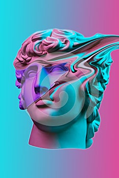 Plaster sculpture of young man face in a pop art style. Statue of Antinous head. Creative concept colorful neon image