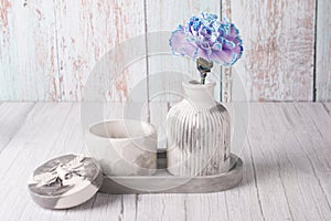 plaster vase for flowers on a wooden background.