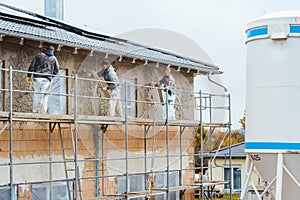 Plaster worker on scaffold working