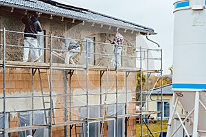 Plaster worker on scaffold working