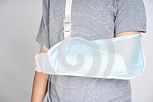 Plastered arm, broken arms at teenagers on a white background