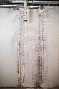 Plastered blank wall with a new house under construction