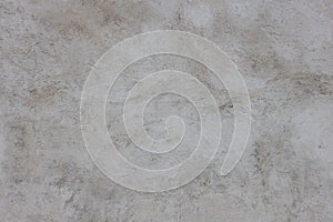 Plastered grey concrete wall surface as a seamless texture and full frame background