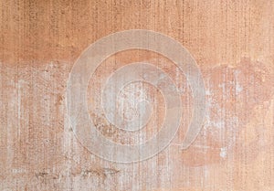 Plastered, painted and faded peachy wall background photo