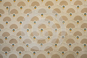 Plastered wall with art deco pattern in yello beige and blue