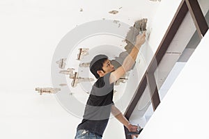 Plasterer at ceiling renovation decoration