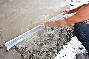 Plasterer concrete worker at floor work