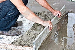 Plasterer concrete worker at floor work