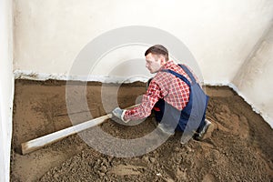 Plasterer concrete worker at floor work