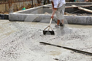 A plasterer concrete worker at floor work