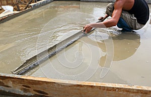 A plasterer concrete worker at floor work