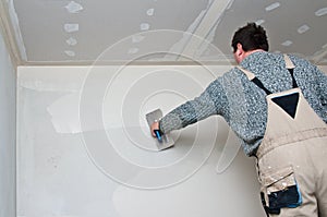 Plasterer or dry waller at work photo