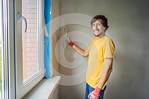 Plasterer home improvement handyman worker with putty knife working on apartment wall filling