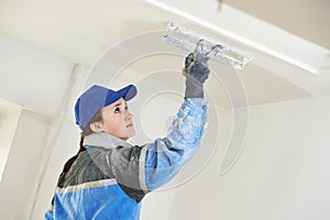 Plasterer at indoor ceiling work