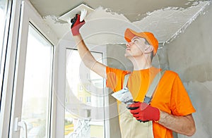 Plasterer at indoor ceiling work