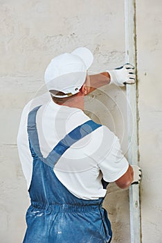 Plasterer at indoor wall renovation