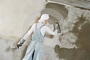 Plasterer at indoor wall work