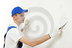 Plasterer at indoor wall work