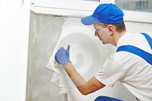 Plasterer at indoor wall work
