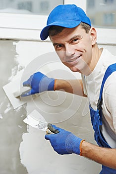 Plasterer at indoor wall work
