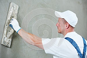 Plasterer at indoor wall work
