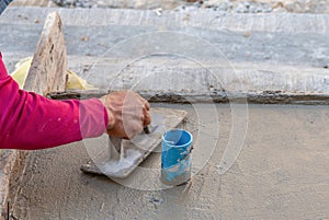 Plasterer man hand using trowel to plastering cement