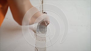 Plasterer putting plaster on wall. Worker covers the wall with mortar