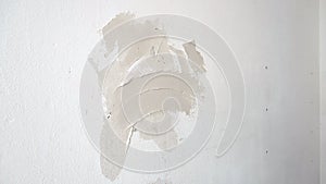 Plasterer puttying holes in the wall