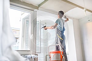 Plasterer renovating indoor walls and ceilings. photo