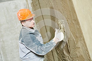 Plasterer at work with wall