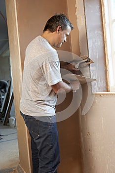 Plasterer Working On Interior Wall