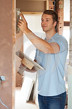 Plasterer Working On Wall