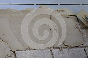 Plasterers are plastering the walls of the house in industrial work.