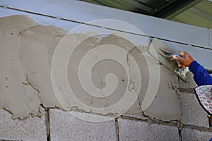 Plasterers are plastering the walls of the house in industrial work. photo