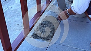 .Plasterers use a shovel to mix the mortar together in the mortar mixing container.