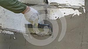 Plastering cement at wall for renovation house. Plasterer smoothing plaster on wall. Putty brick wall background