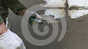 Plastering cement at wall for renovation house. Plasterer smoothing plaster on wall. Putty brick wall background