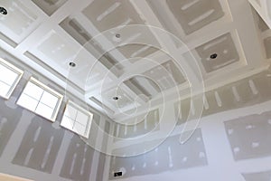 Plastering drywall new home industry on finishing putty in the room walls plasterboards with room under construction photo