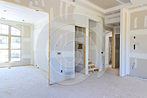 Plastering drywalling newly constructed house during a construction phase