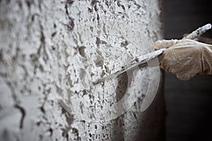 Plastering the wall. Hand holding a spatula with construction mix .Internal construction and finishing works