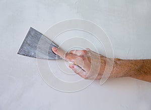Plastering wall with plaste and plaster spatula trowel