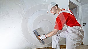 Plasterwork and wall painting preparation. craftsman applying plaster or filling