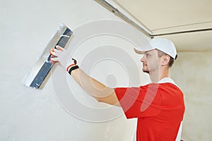 Plasterwork and wall painting preparation. craftsman applying plaster or filling