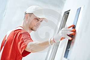 Plasterwork and wall painting preparation. craftsman applying plaster or filling