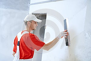 Plasterwork and wall painting preparation. craftsman applying plaster or filling