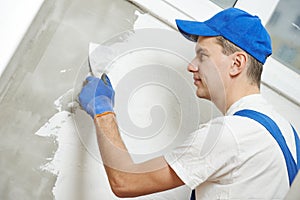 Plasterwork and wall painting preparation. craftsman applying plaster or filling