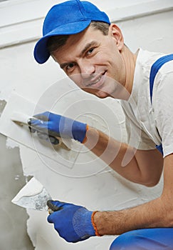 Plasterwork and wall painting preparation. craftsman applying plaster or filling