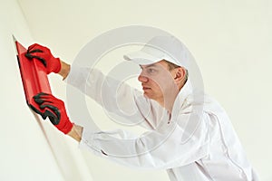 Plasterwork and wall painting preparation. craftsman applying plaster or filling